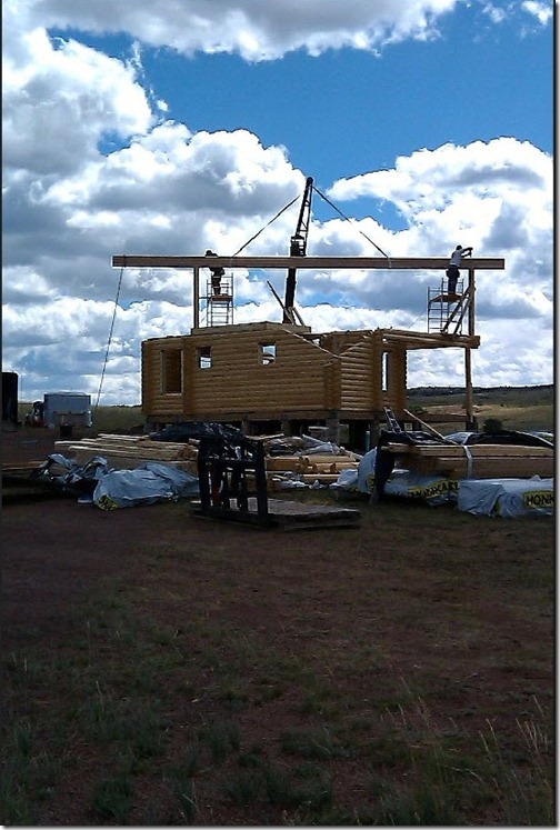 Here we can see them flying in the glulam ridge beam with a boom truck. We can see the diagonal cuts on the wall are already done in the factory.